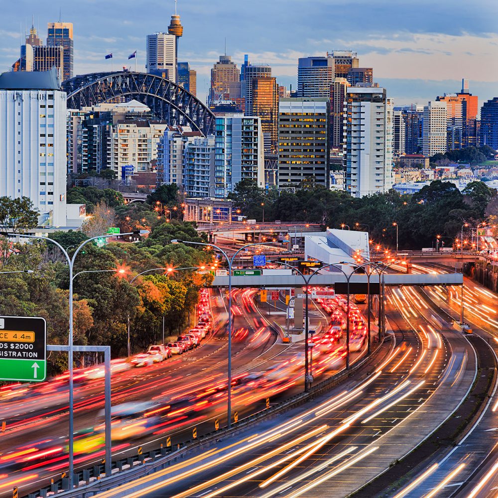 Sydney cityscape showing a busy highway with blurred car lights.